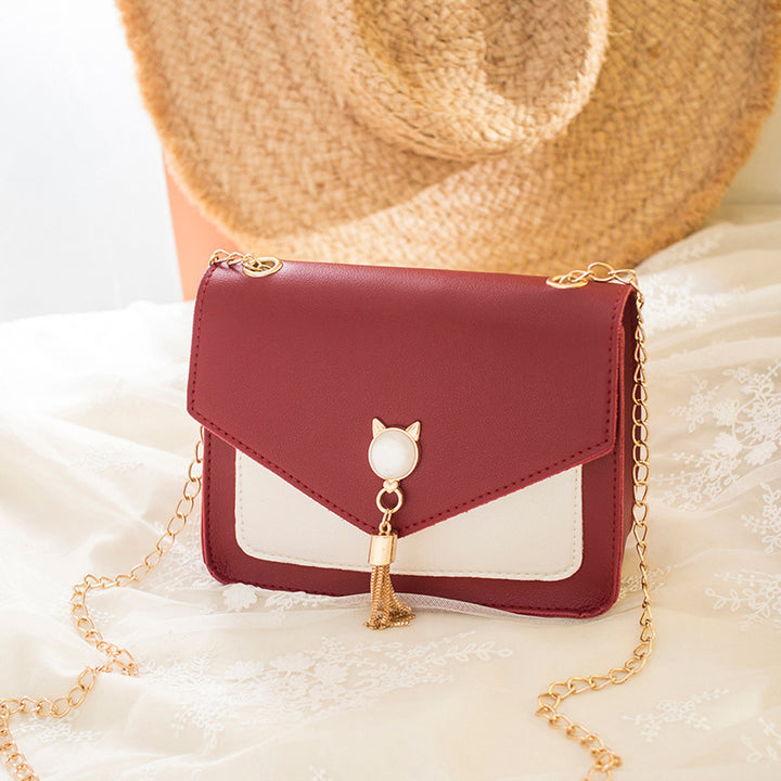 Liten crossbody-veske med kattelås i rosa